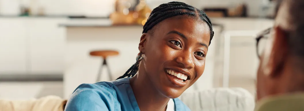 Medical caregiver consulting with senior patient at home