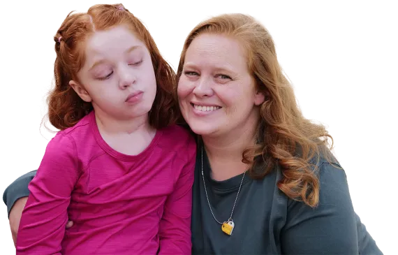 Mother smiling next to her disabled daughter