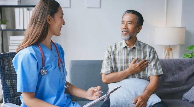 Community health worker talking to man