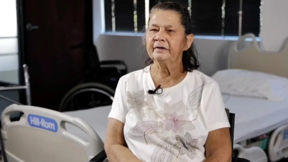 Home Assist Health caregiver sitting and talking in a medical room